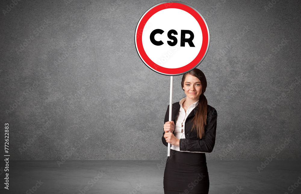 © ra2 studio - Young business person holdig traffic sign