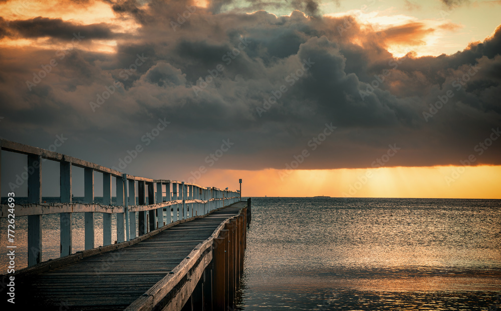 The view of the ocean and Sorrento Long Pier under the sunbeam in Mornington Peninsula in Melbourne at dawn 