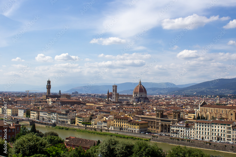 Florence's historic skyline unfolds with the iconic Duomo and Palazzo Vecchio, framed by the Arno River and lush Tuscan hills.