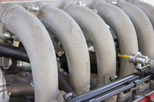 A close-up view of a car's intake manifold, highlighting the curved pipes that facilitate air distribution to the engine for optimal performance