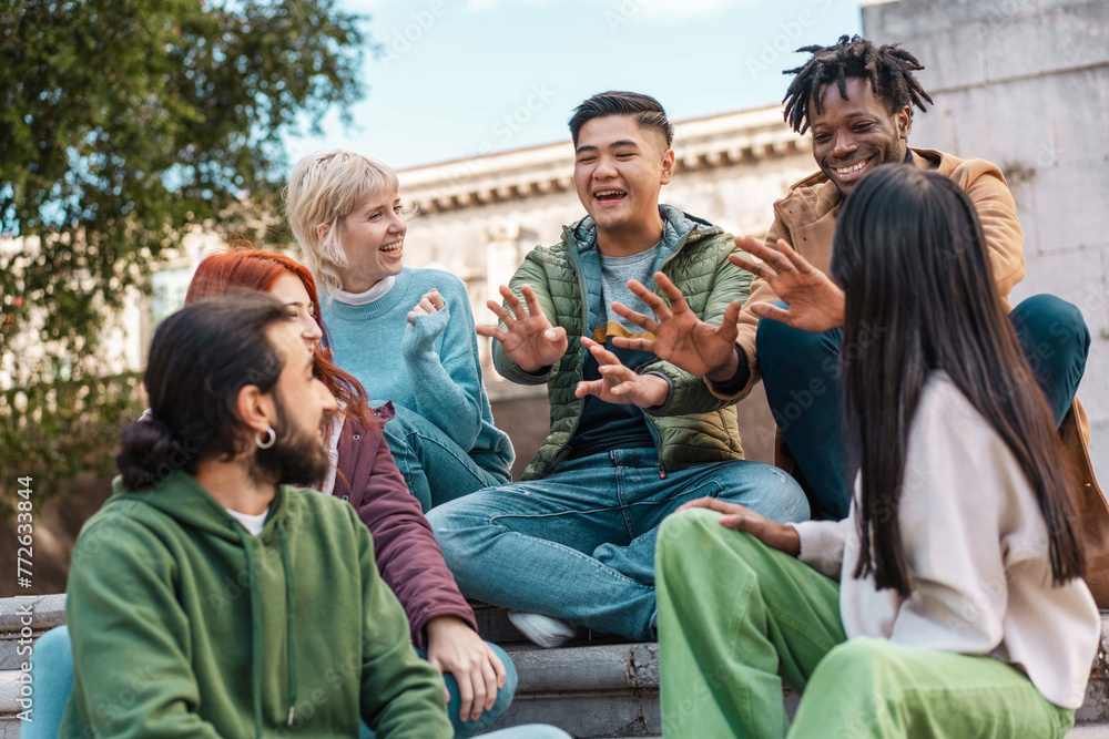 Vibrant group of multicultural students sharing a joyful moment, symbolizing the spirited camaraderie and diversity of university life - multiethnic friends interacting in the campus Vibrant group of multicultural students sharing a joyful moment, symbolizing the spirited camaraderie and diversity of university life - multiethnic friends interacting in the campus
