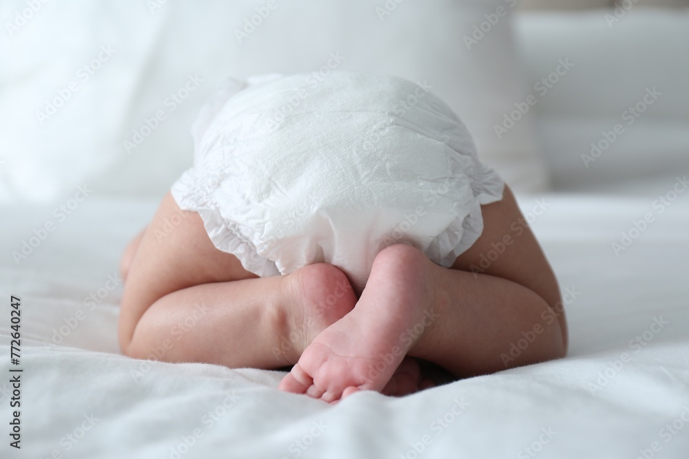 Cute little baby in diaper on bed Cute little baby in diaper on bed