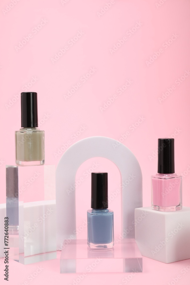 Stylish presentation of nail polishes on pink background Stylish presentation of nail polishes on pink background