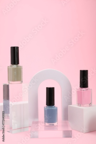 Stylish presentation of nail polishes on pink background © New Africa
