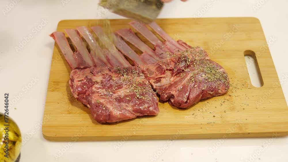 A man generously sprinkles spices on fresh beef before cooking. He carefully distributes the spices over the entire surface of the meat, the spices create an appetizing aroma and taste. A man generously sprinkles spices on fresh beef before cooking. He carefully distributes the spices over the entire surface of the meat, the spices create an appetizing aroma and taste.