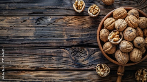 Wooden background with walnuts and nutcracker on the table