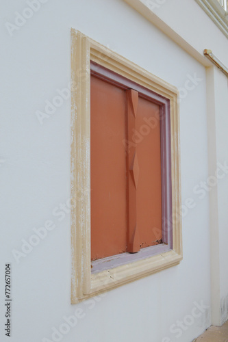 the facade of a house with a wooden window © mansum008