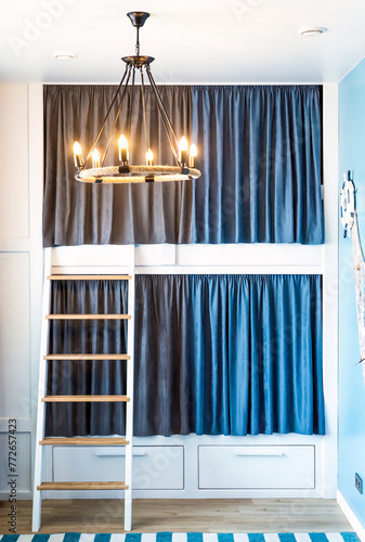 Bunk bed for boyd with blue gray curtains in the bedroom without people photo