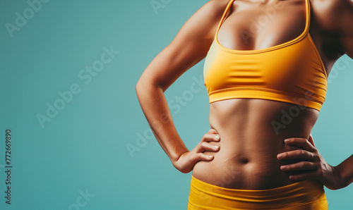 normal soft fit woman in gym workout clothes isolated on plain blue color studio background and copy space