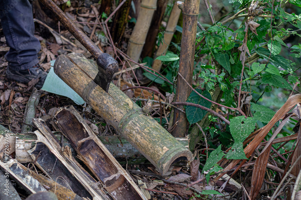 Man holding heavy Axe in lumberjack hands chopping or cutting wood trunks Man holding heavy Axe in lumberjack hands chopping or cutting wood trunks