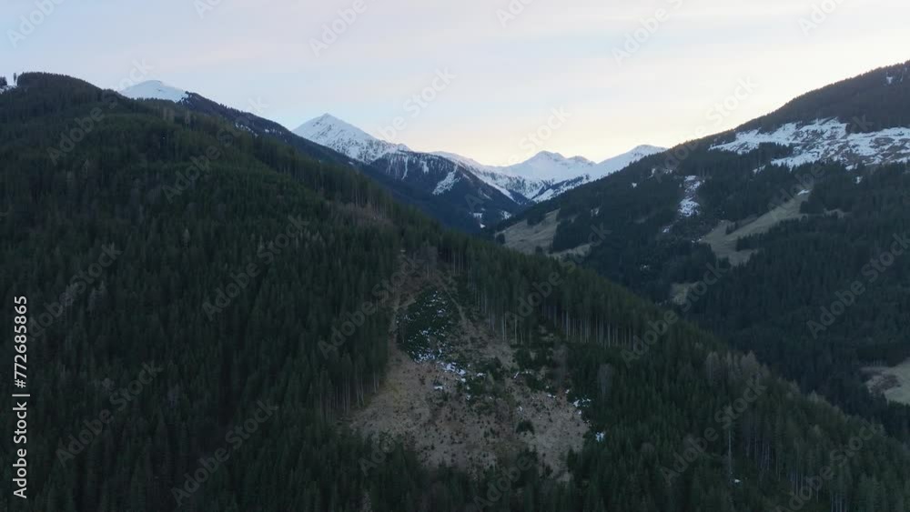 Saalbach-Hinterglemm ski resort in Austria with snow-capped mountains during dusk, aerial view Saalbach-Hinterglemm ski resort in Austria with snow-capped mountains during dusk, aerial view