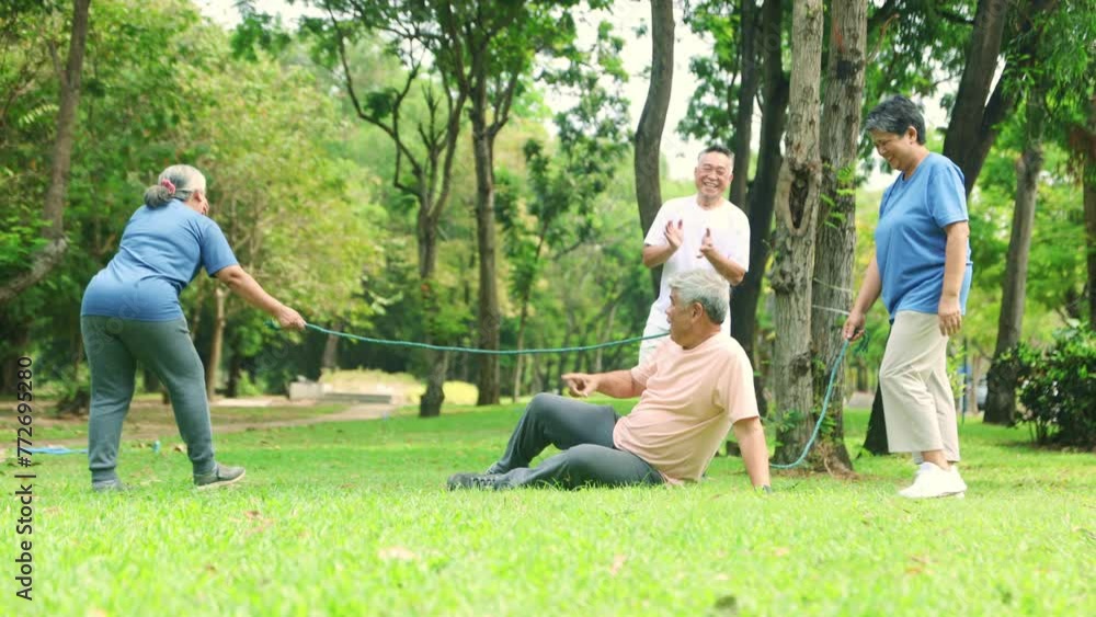 Group asian senior citizens join together outdoor exercise activities dividing into teams playing ropes competing in running finish line find the winner laughing happy in the park cheering good mood. Group asian senior citizens join together outdoor exercise activities dividing into teams playing ropes competing in running finish line find the winner laughing happy in the park cheering good mood.