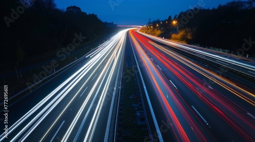 A long exposure shot of a highway at night with blurred streaks of car headlights and taillights showing the fastpaced nature of traffic at high levels.