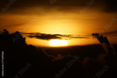 Sun rising from the clouds with dynamic colors