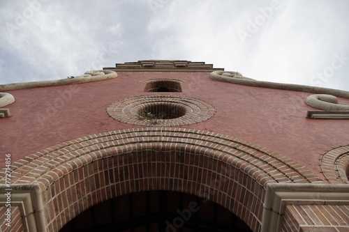 wall with window circle brick church Spanish style and bell tower