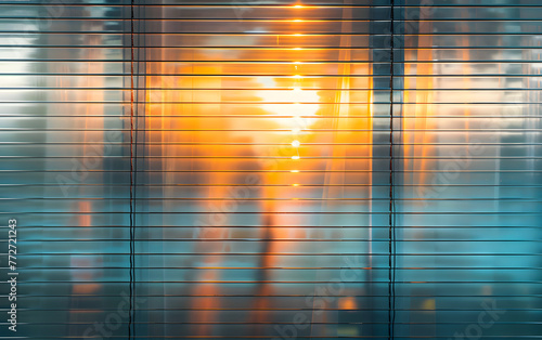 A blurry image of a city street with a person walking in the foreground. The image has a dreamy, ethereal quality to it, with the sun shining through the window blinds