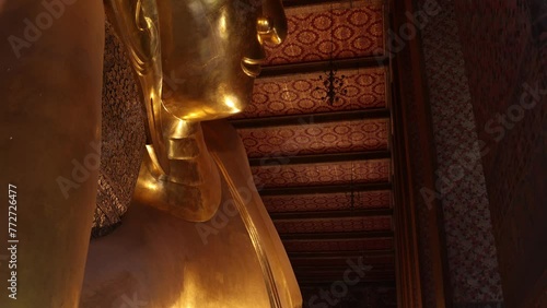 golden head of reclining buddha in a temple in the Rattanakosin old town of Bangkok, Thailand photo
