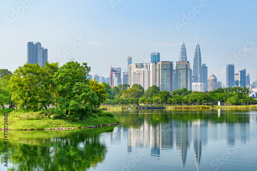 Kuala Lumpur skyline. Scenic lake in a city park