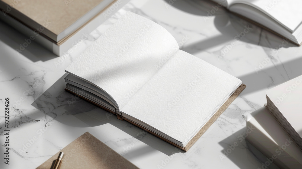 The image shows an open book with blank label laying on a marble surface, creating a sophisticated atmosphere with soft shadows and sunlight The image shows an open book with blank label laying on a marble surface, creating a sophisticated atmosphere with soft shadows and sunlight