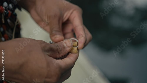 Huaorani preparing a fish Hook photo