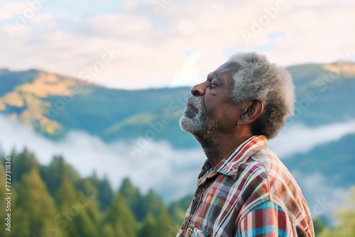African man enjoying the fresh morning air on the mountain, calming refreshing