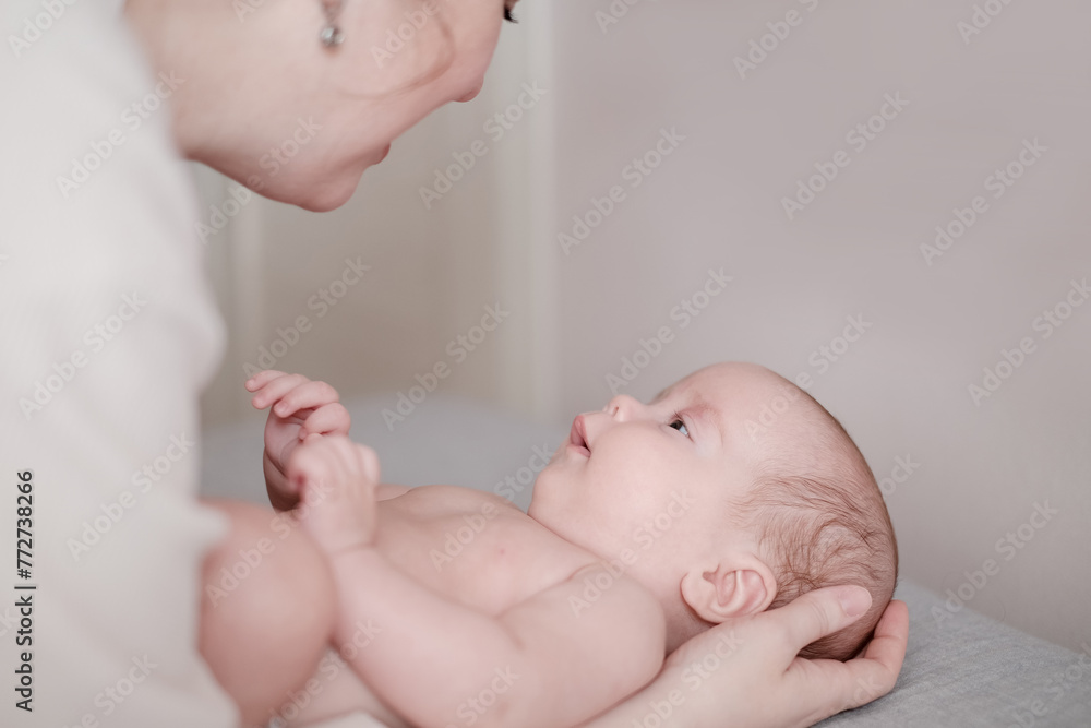 Mother playing with her newborn baby. Parenthood, childhood, motherhood Mother playing with her newborn baby. Parenthood, childhood, motherhood