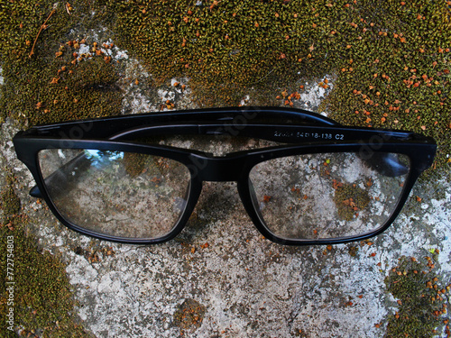 Top view of an eyeglass on the mossy floor. 