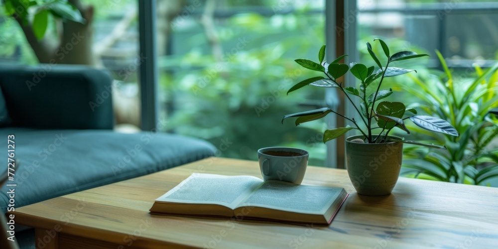 A table displaying a book and a potted plant