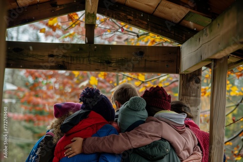 group huddled under playhouse roof