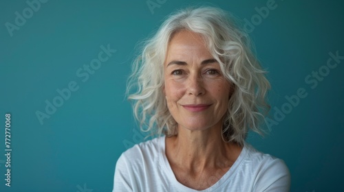 Smiling beautiful mature business woman standing isolated on white background. Older senior businesswoman, 60s grey haired lady professional coach looking at camera, close up face headshot portrait.