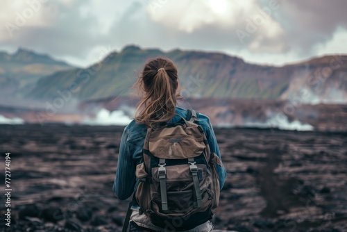 woman with backpack staring at ashcovered landscape