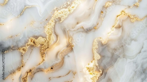 Detailed view of swirling gold patterns on white marble surface