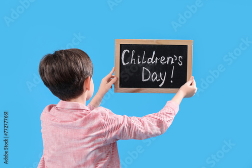 Little boy holding chalkboa...