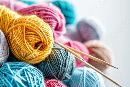 Colorful knitting yarn with needles on a white background, representing needlework and a hobby photo