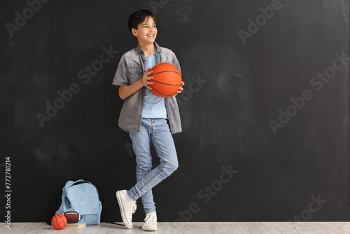 Little boy with ball near b...