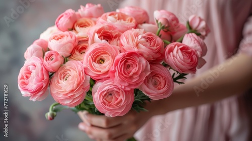   Close-up of a person holding a bouquet of pink roses