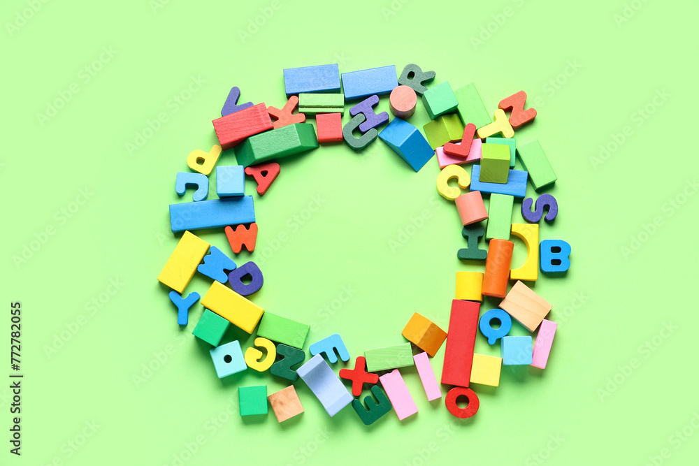 Letter Frame Blocks Frame made of wooden letters and colorful blocks on green background ...