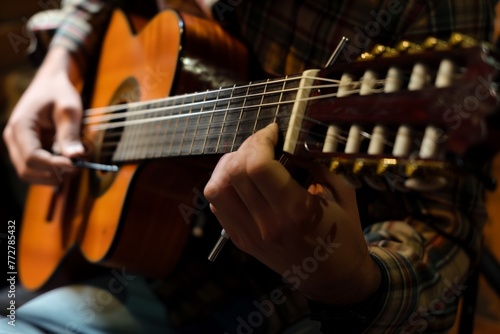 musician tuning guitar before performance