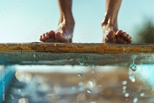 closeup of feet taking off from springboard photo