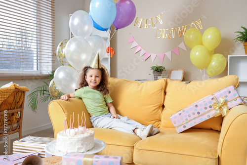 Cute little girl sitting on...