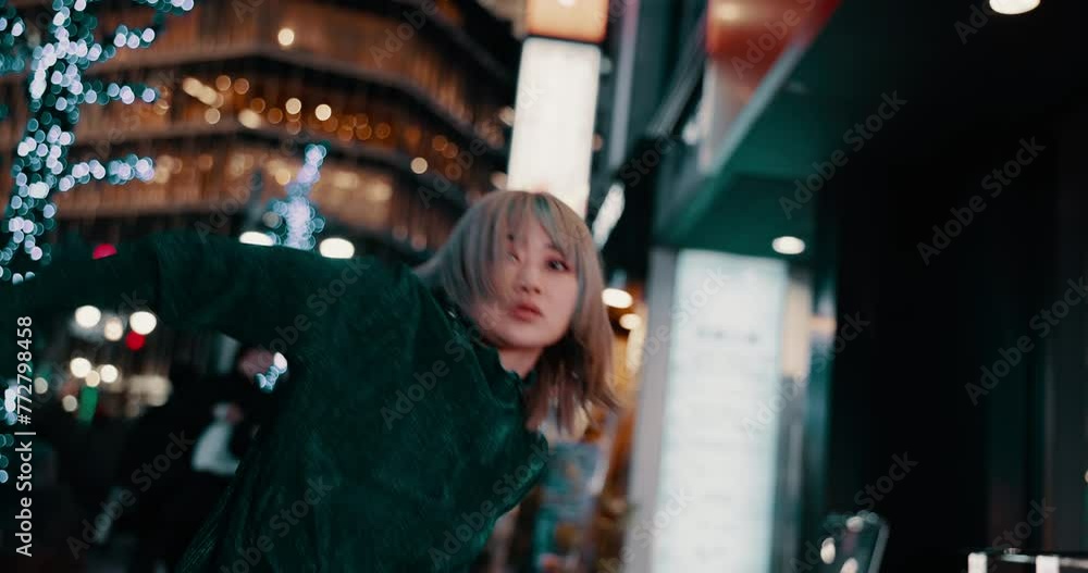City, dance and face of woman in Japan at night on street in trendy clothes, cool outfit and casual fashion. Dancer, confidence and portrait of person with movement, performance and style in road City, dance and face of woman in Japan at night on street in trendy clothes, cool outfit and casual fashion. Dancer, confidence and portrait of person with movement, performance and style in road