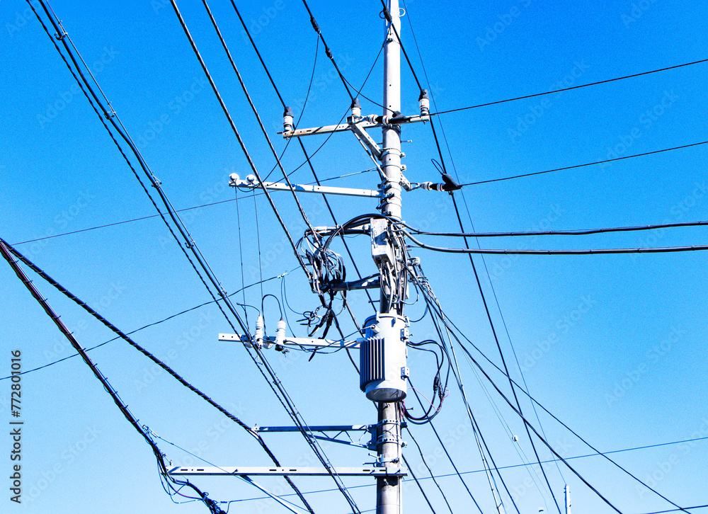 View below of Transformers small sphere size and electric wire phone lines. Energy and technology. Electrical post on electric power. electrical device. Bright sunny blue sky is background. View below of Transformers small sphere size and electric wire phone lines. Energy and technology. Electrical post on electric power. electrical device. Bright sunny blue sky is background.