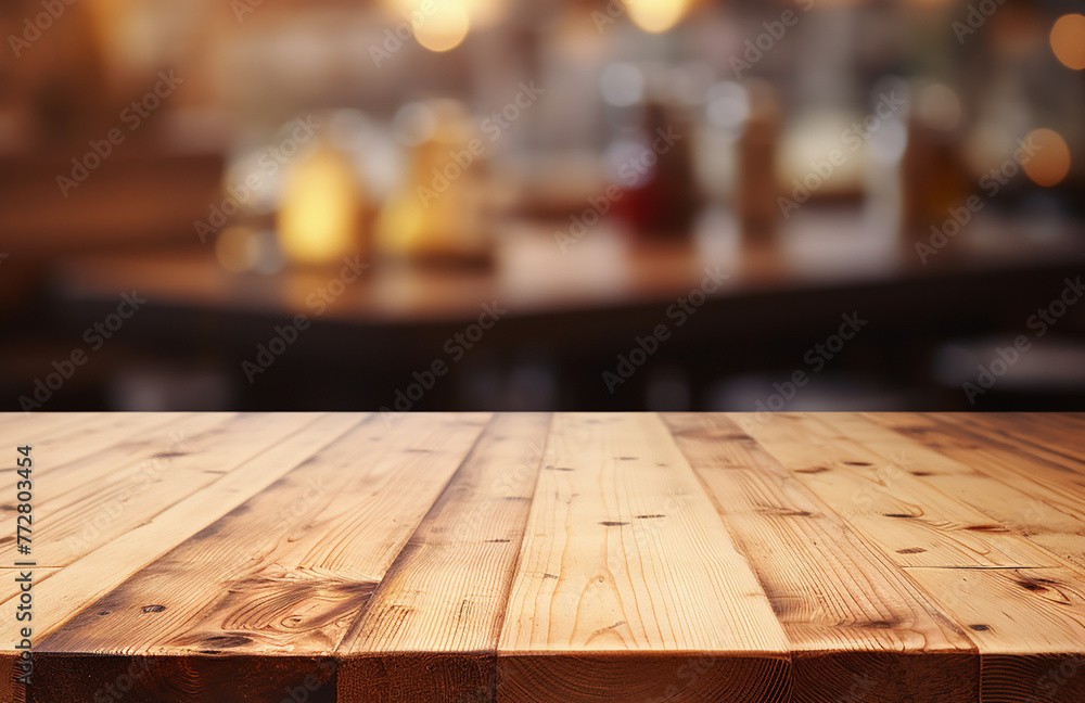 Empty wooden table in front of abstract blurred background