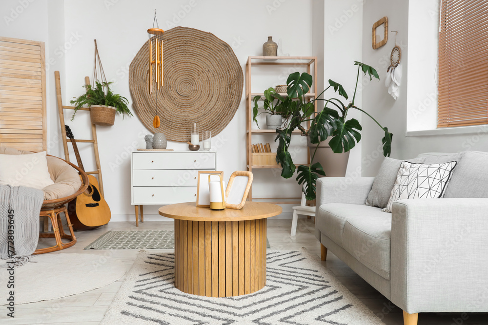 Obraz premium Interior of living room with wind chime, sofa and table