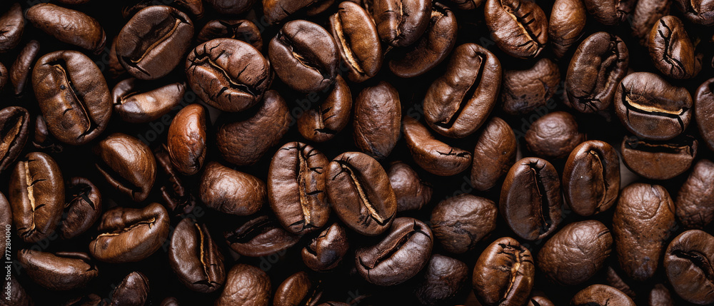 Roasted coffee beans on the table for background or design, top view. Coffee beans texture for background. Roasted coffee beans on the table for background or design, top view. Coffee beans texture for background.
