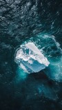 Aerial view of a lone iceberg in the ocean