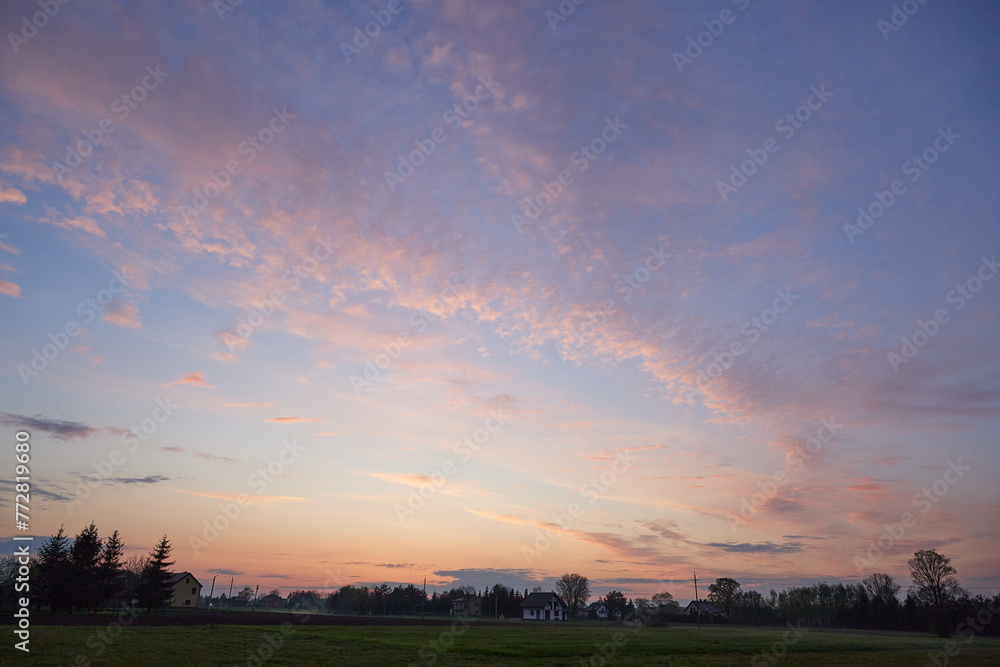 Pink and dark lilac scenic clouds in sunset sky after rain. Pink and dark lilac scenic clouds in sunset sky after rain.