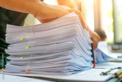 Businessman hands searching information in Stack of papers files on work in office, business report paper or piles of unfinished documents achieves with clips on offices Business concept photo