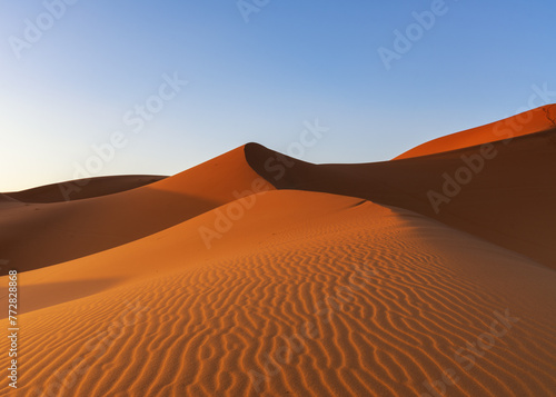 view of the sand dunes at Erg Chebbi in Morocco in warm evening light