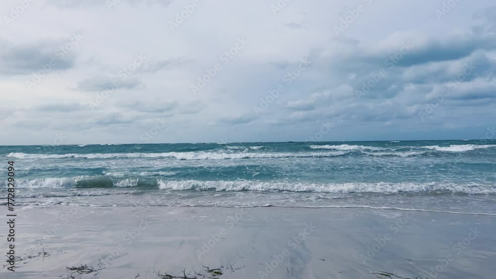A beautiful Cuban beach in Varadero, Cuba, where you can see the waves and ocean waters on a cloudy day with the sun breaking through the clouds. Turquoise waves. 4K Video A beautiful Cuban beach in Varadero, Cuba, where you can see the waves and ocean waters on a cloudy day with the sun breaking through the clouds. Turquoise waves. 4K Video